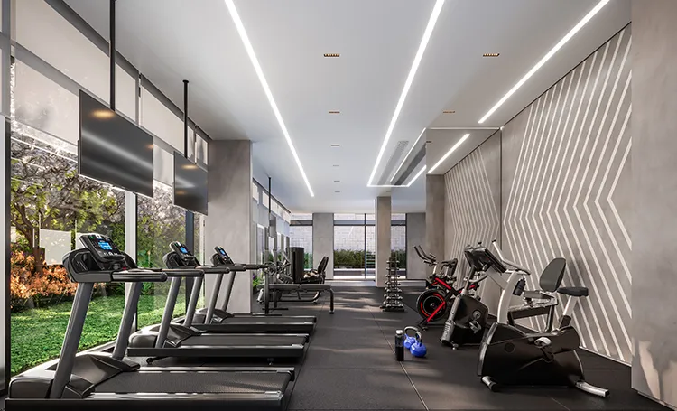 Academia com esteiras, bicicletas e painel iluminado