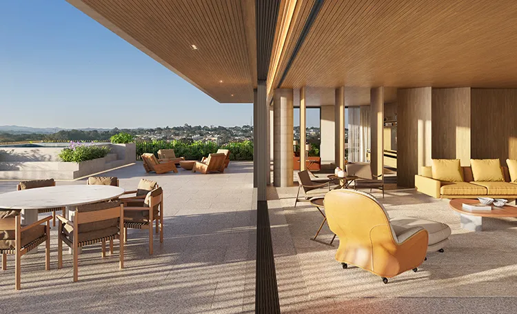 Terraço coberto do Kaa com mesa de jantar e poltrona amarela