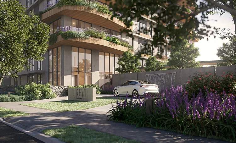 Acesso do Trevi Batel com carro, canteiro de lavanda e fachada com varandas