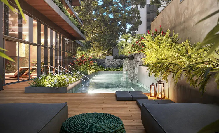 Deck com piscina, bancos e vegetação ao lado do prédio