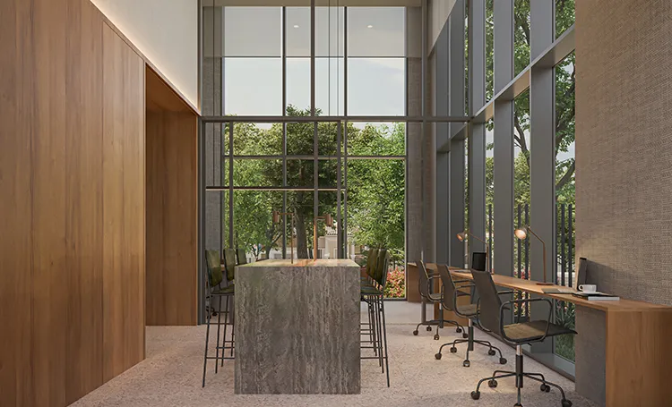 Hall com pé-direito alto, bancada de pedra e mesas de trabalho