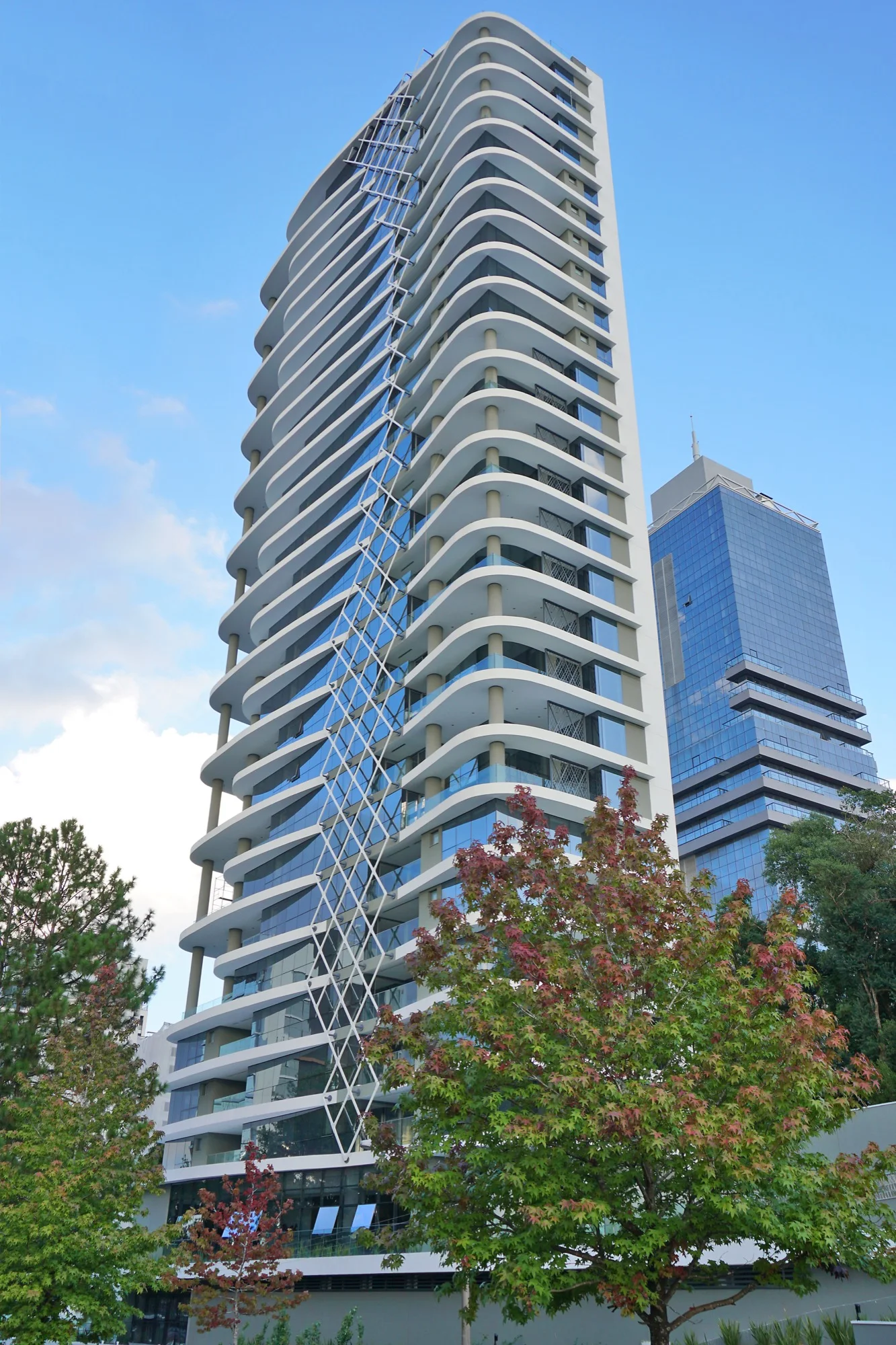 Torre do MAI Home com varandas curvas e céu azul